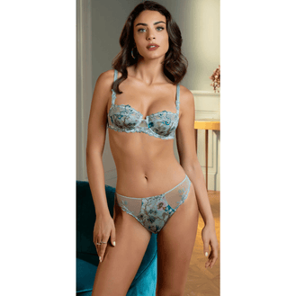 Woman wearing a floral lingerie with a background showing front