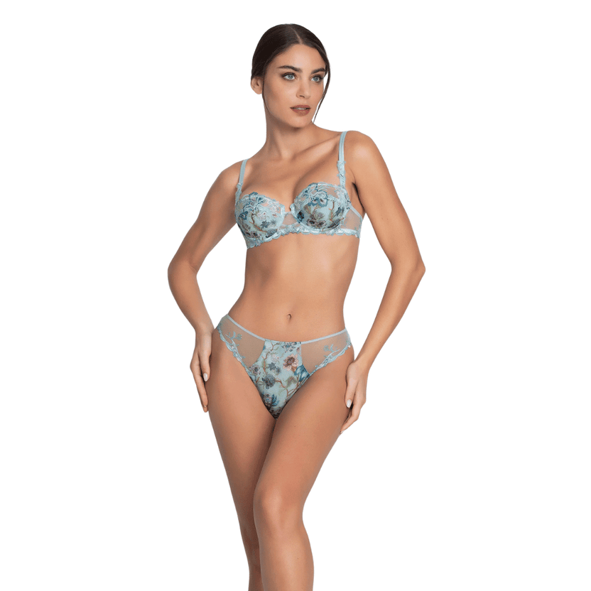Woman wearing a floral lingerie set on a white background