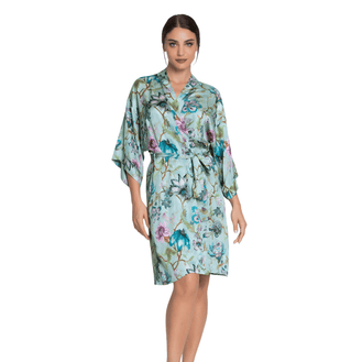 Woman wearing a floral Dressing Gown on a white background
