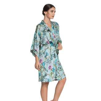 Woman wearing a floral Dressing Gown on a white background side